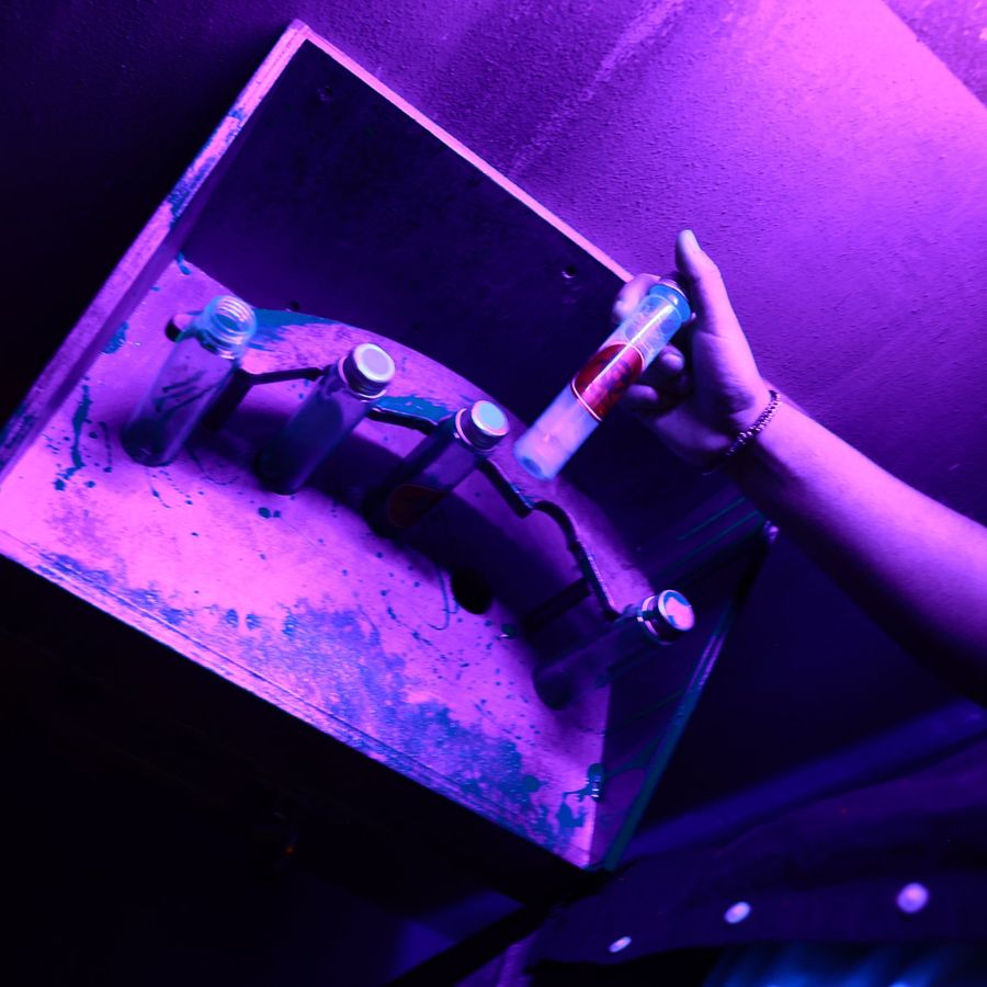 A player placing vials under blacklight in the Alien Escape room