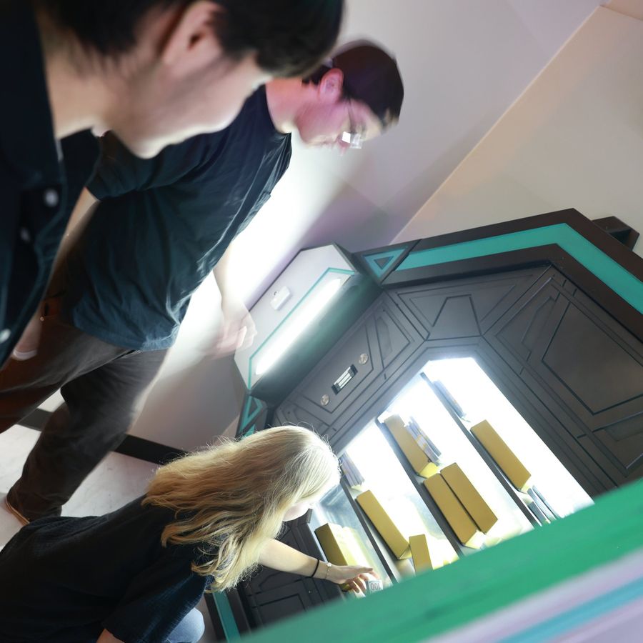 Players opening the vault and revealing gold bars in the Denver Bank Heist room