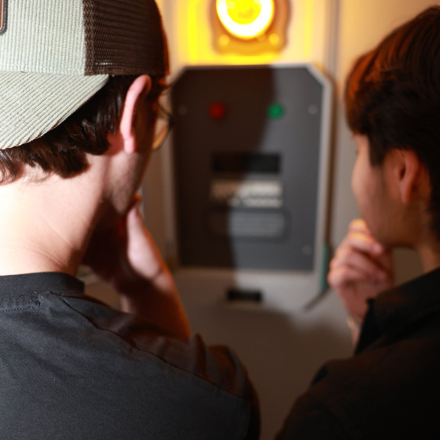 A team watching the alarm light during the Denver Bank Heist escape room