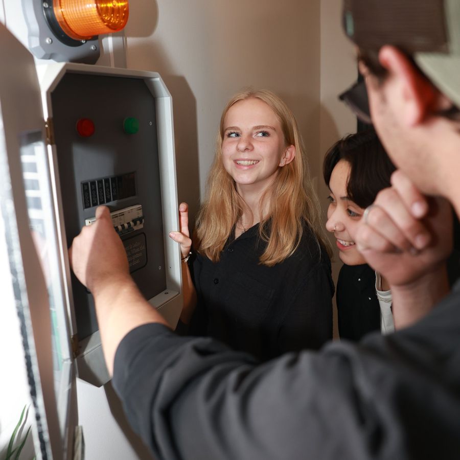 A woman working a control panel in the Denver Bank Heist escape room